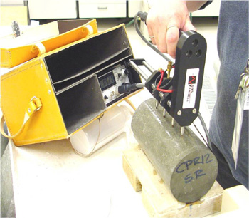 surface resistivity test being performed on a cylindrical test specimen